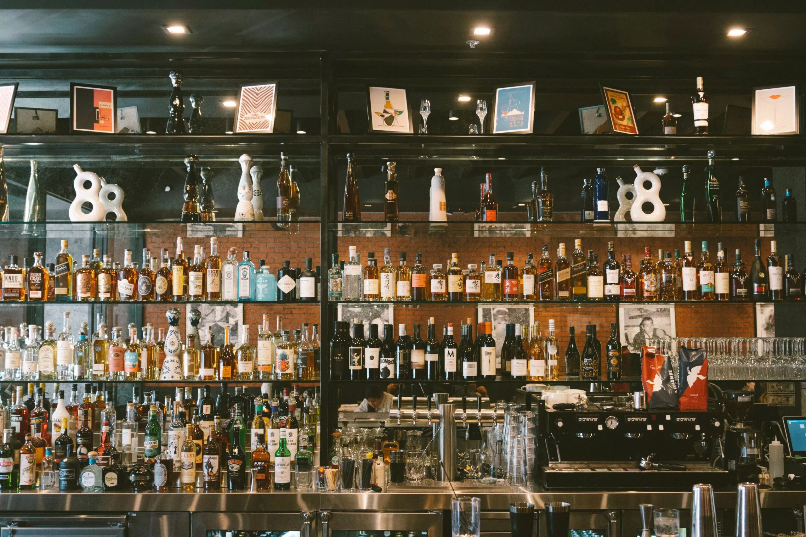 The Beverly Bar interior &mdash; back bar with curated spirits and warm ambient lighting